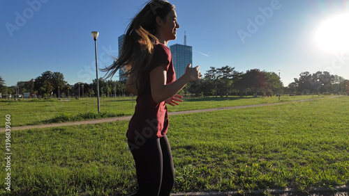 Obraz na płótnie Young woman running and jogging in urban park Slow motion video.. w salonie