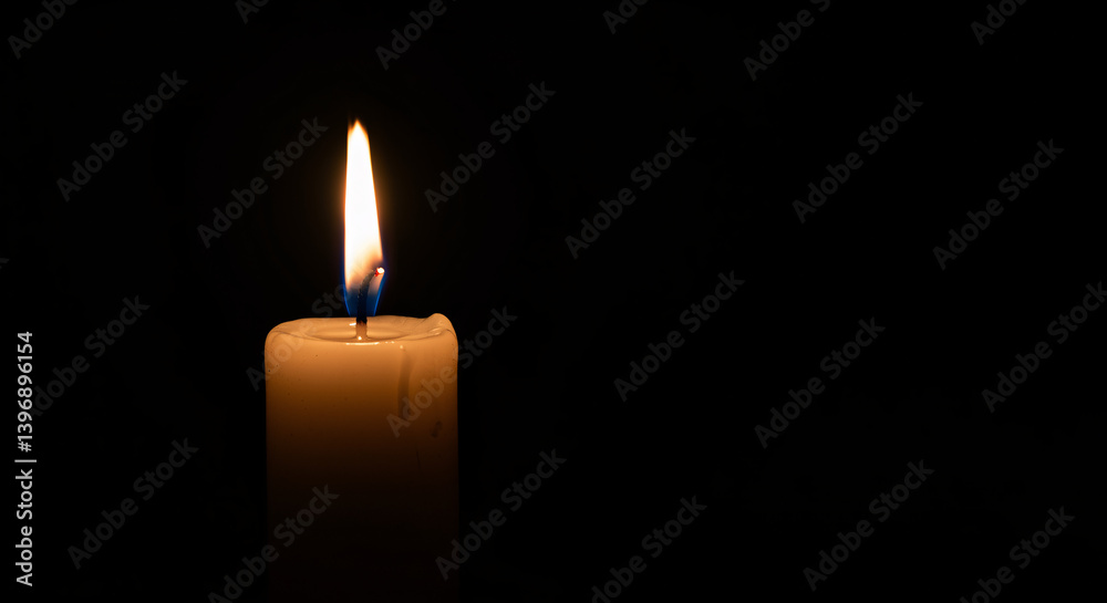 Religious symbols of Easter, Flickering candle flame casting a warm glow in darkness Religious symbols of Easter, Flickering candle flame casting a warm glow in darkness