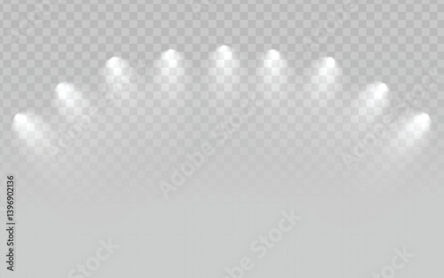 A set of bright white spotlights arranged in a semi-circular arc, shining downwards with a hazy or smoky effect, on a transparent light gray checkered background. Suitable for stage lighting, concerts