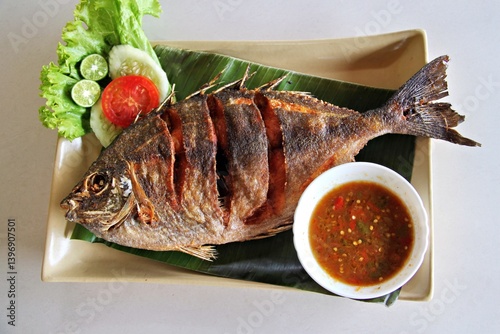 Fried baronang fish served with spicy seafood sambal. A crispy, savory Indonesian seafood dish with bold flavors and a perfect balance of heat and crispiness.