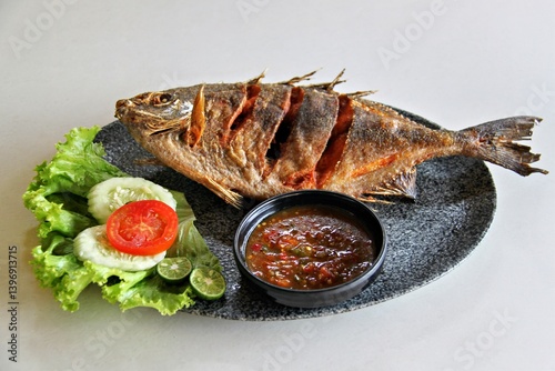 Fried baronang fish served with spicy seafood sambal. A crispy, savory Indonesian seafood dish with bold flavors and a perfect balance of heat and crispiness.