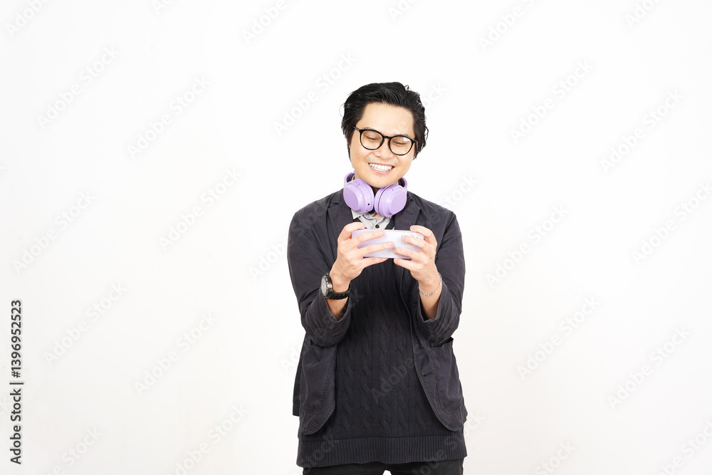 Smile Happy while Playing game on smartphone Of Handsome Asian Man Isolated On White Background Smile Happy while Playing game on smartphone Of Handsome Asian Man Isolated On White Background