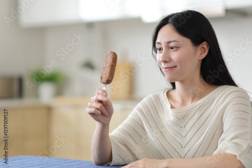 Canvas Print Asian woman looking at ice cream ready to taste