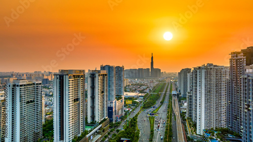 Obraz na płótnie Aerial view of Saigon cityscape with a complex highway intersection. Urban development texture, transport infrastructure, Financial and business centers w salonie