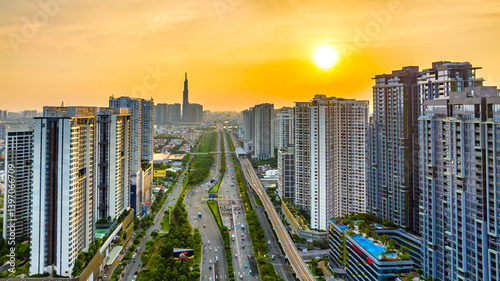 Obraz na płótnie Aerial view of Saigon cityscape with a complex highway intersection. Urban development texture, transport infrastructure, Financial and business centers w salonie