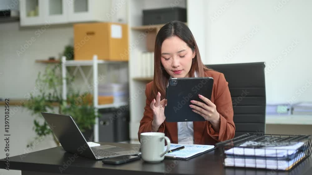 Business woman using tablet and laptop for doing math finance on an office desk, tax, report Business woman using tablet and laptop for doing math finance on an office desk, tax, report