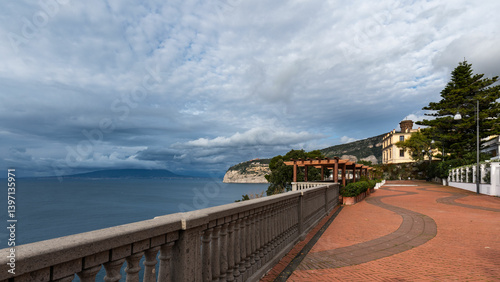 Dramatic view from a panoramic terrace in Sant'Agnello, overlooking the Gulf of Naples and Mount Vesuvius on a cloudy, stormy day.Sorrento Coast, Italy