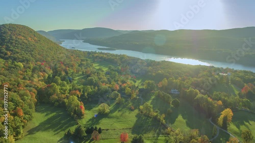 A 4K drone shot of the historic Bannerman Castle in Hudson Valley, showcasing the stunning fall colors and scenic views under sunny skies with clouds.