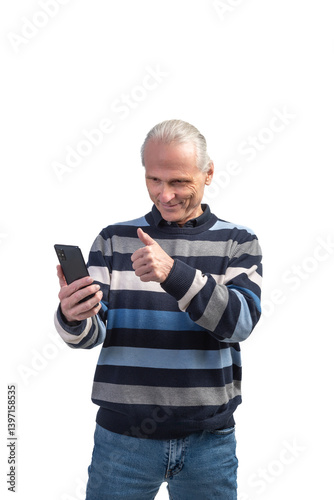 Happy senior man using smartphone and showing thumbs up gesture on white background