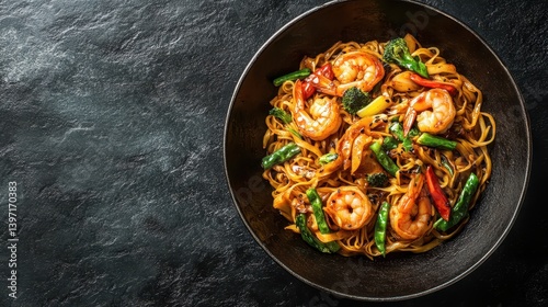 A bowl of shrimp stir-fry noodles with colorful veggies and black sesame seeds. Showcase Asian cuisine for restaurants, blogs, or recipe promotions.