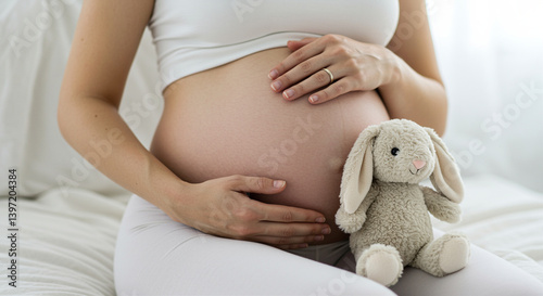 Pregnant woman holds belly with bunny pregnancy lifestyle expecting mother baby care motherhood family parenthood maternity prenatal trimester healthy belly