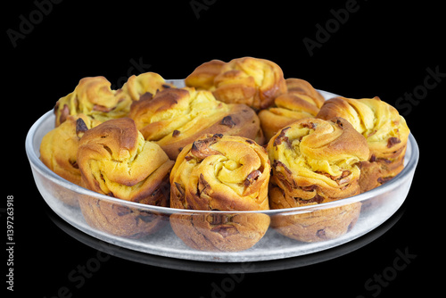 Easter cakes on a glass dish, isolated on a black background. Selective focus