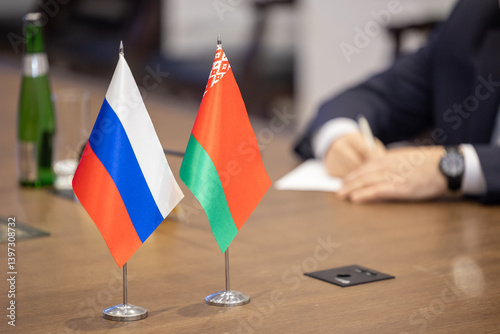 Flags of cooperation between Russia and Belarus. Flags of Russia and Belarus on the negotiating table. Ideal for news.
