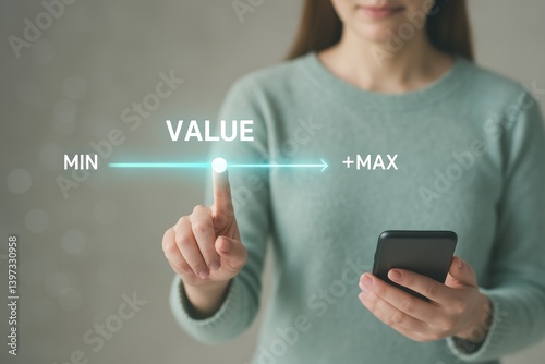 Businesswoman is using a futuristic touchscreen interface increasing value from minimum to maximum level with her finger and holding a smartphone in her other hand
