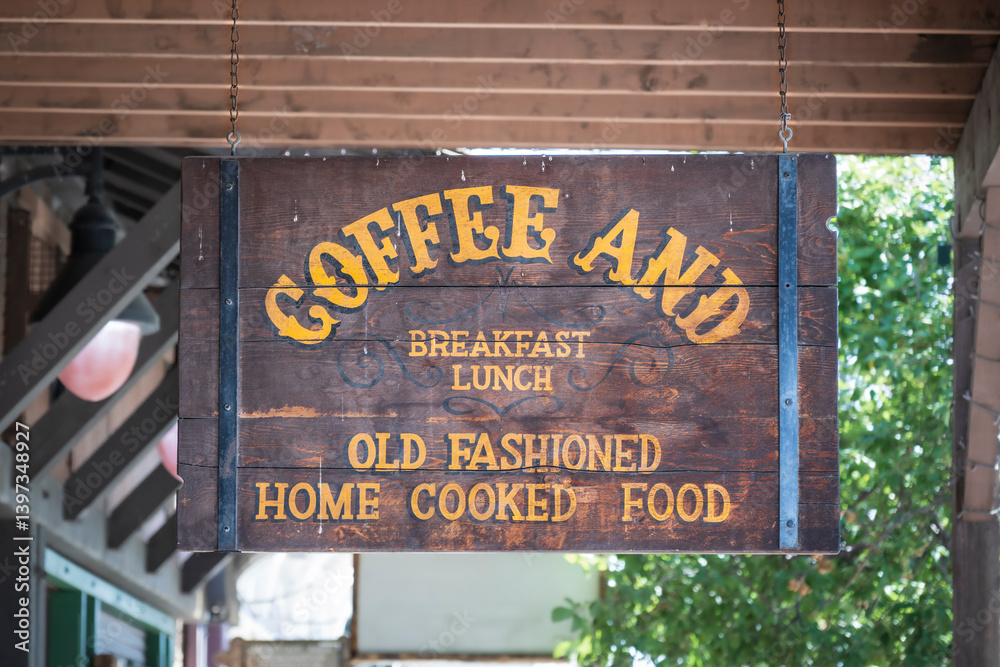 Obraz premium An old fashioned wooden sign, advertising coffee and food on a old time American main street