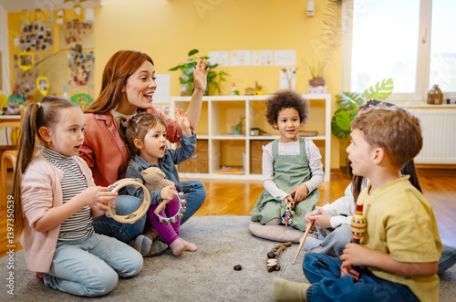 Konstfotografi Multicultural group of preschool children playing musical instruments with a kin