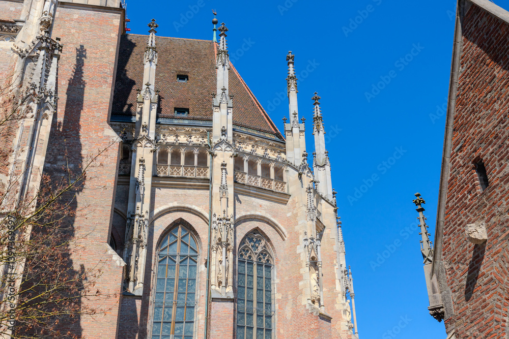 Obraz premium HDR image of Ulm Minster, the tallest church in the world, showcasing Gothic details under a clear blue sky on a sunny day. Perfect for travel, architecture, historical and inspiring design projects.