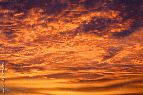 Fototapeta Naklejka Na Ścianę i Meble -  A breathtaking sunset paints the sky in shades of orange, purple, and gold, creating a stunning scene.