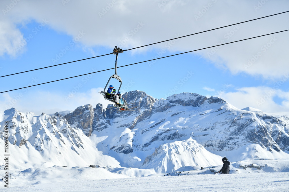 Ski resort view by winter with ski lift skiers on the slopes Ski resort view by winter with ski lift skiers on the slopes