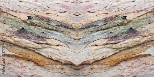 Wooden layered planks in earthy tones forming a v shaped abstract chevron structure with textured recycled materials appearing as rustic panel art