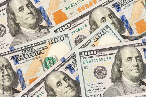 Scattered US hundred dollar bills with Benjamin Franklin portrait. Flat lay composition of American banknotes for finance and investment concept.