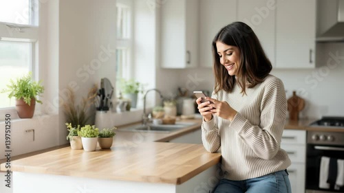 Modern Woman Using Smartphone in Bright Minimalist Kitchen Interior.