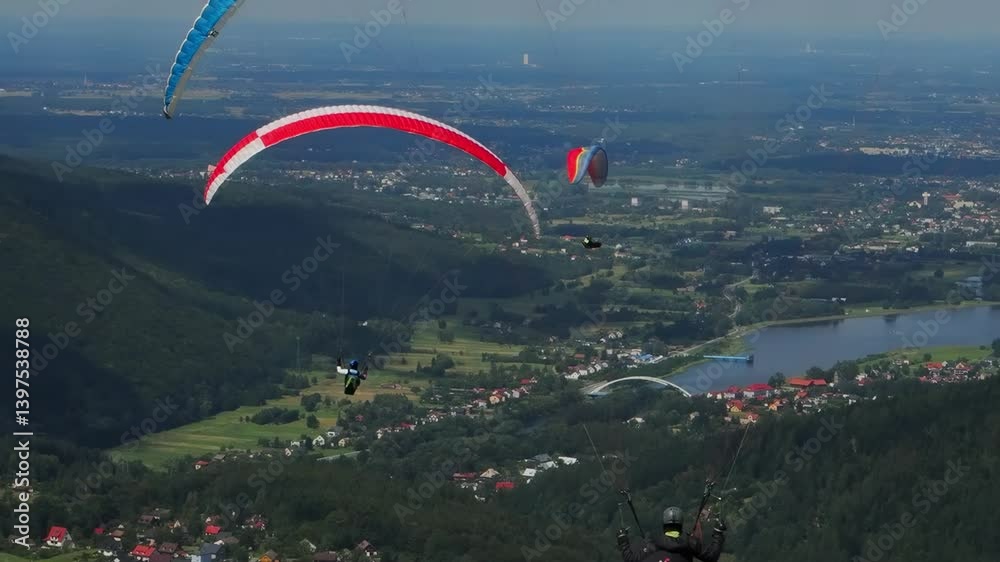  man takes off on a paraglider over stunning landscapes with breathtaking views of mountains and lakes. slow motion
