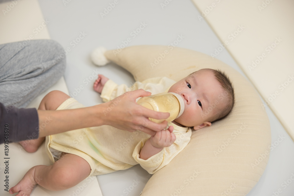 Newborn baby lying down drinking milk