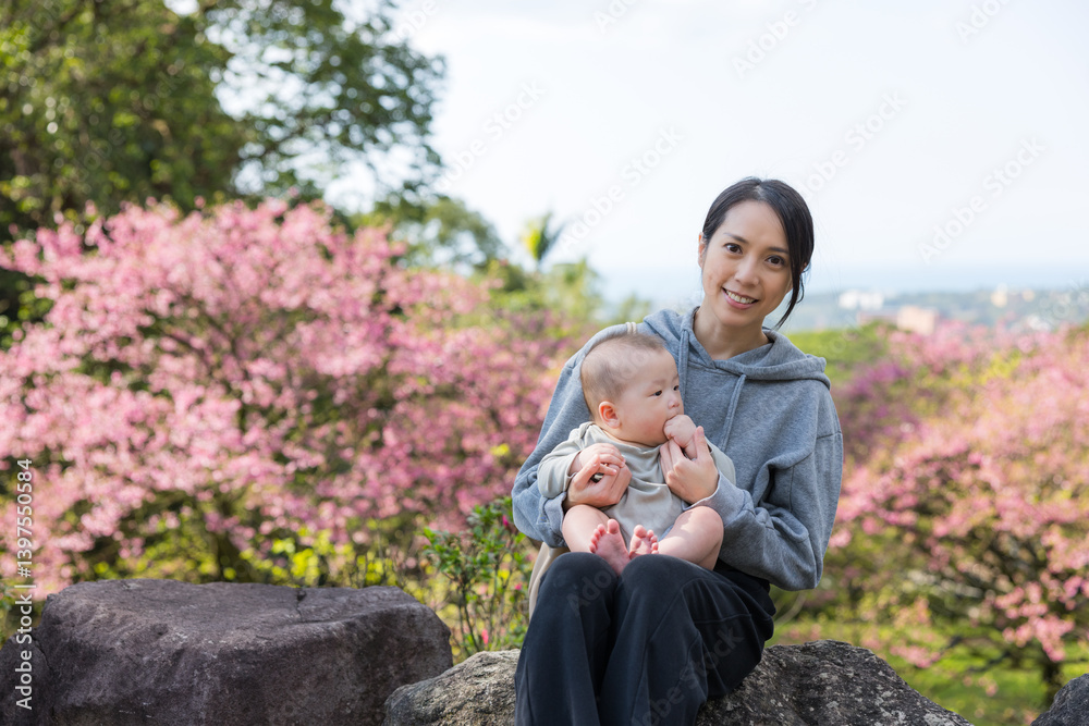Happy family sitting under cherry blossom tree