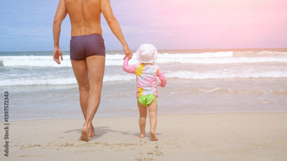 Naklejka premium Father and daughter walking on tropical beach