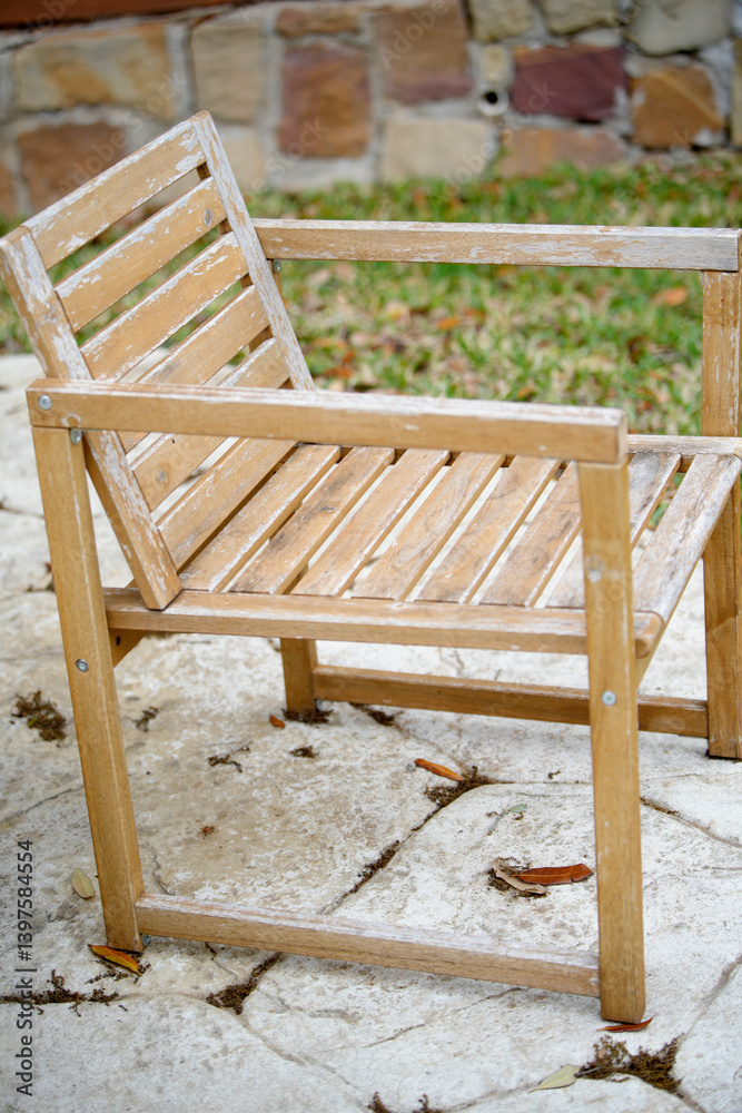 Weathered wooden chair sitting on patio in backyard Weathered wooden chair sitting on patio in backyard