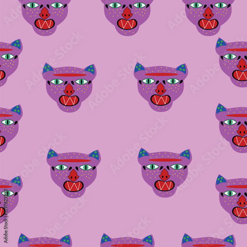 Seamless pattern with pink tribal-style animal faces on a bright pink background. Abstract and bold design with wide green eyes, red nose, and triangular teeth.