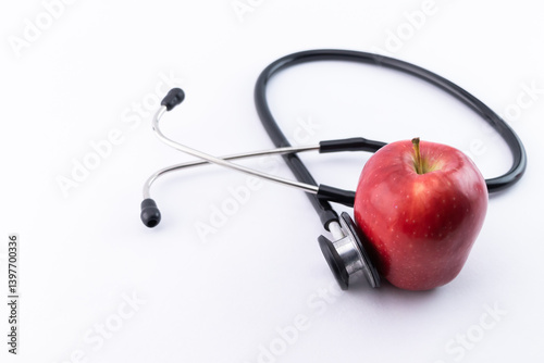 Stethoscope and red apple on the white background - Healthy lifestyle concept.