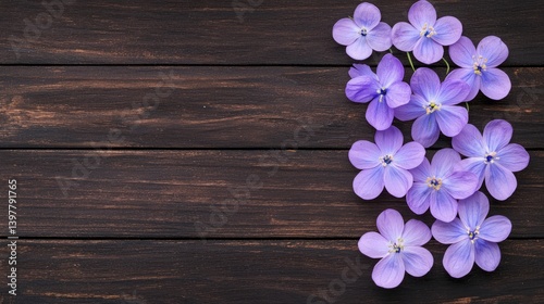 Flower wooden board weather. A cluster of delicate purple flowers scattered on a dark wooden surface, showcasing their vibrant color against a natural backdrop.