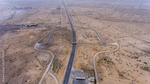 Aerial view of hyderabad motorway intersecting arid desert landscape, hyderabad, sindh, pakistan.