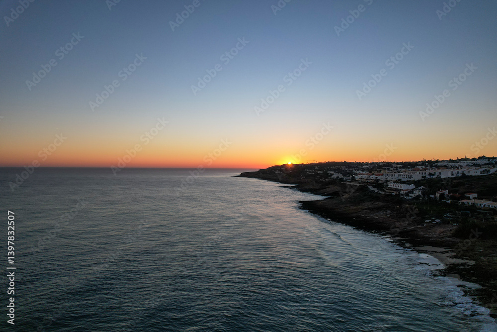 Aerial view of beautiful beach at sunset with calm waves and serene coastline, Algave, Portugal. Aerial view of beautiful beach at sunset with calm waves and serene coastline, Algave, Portugal.