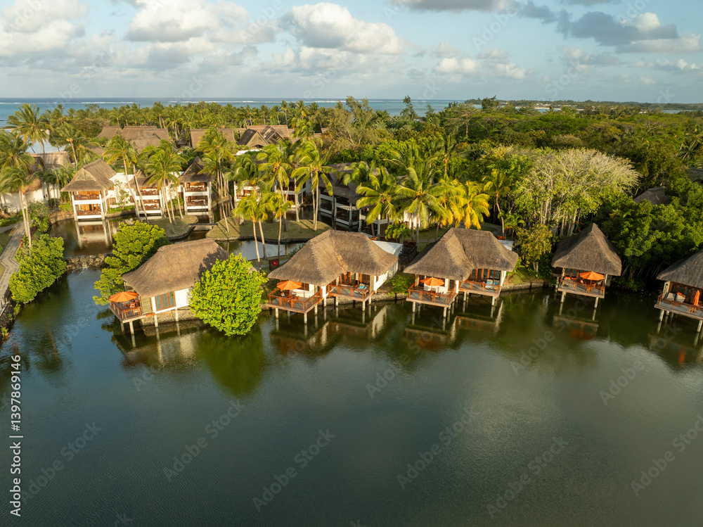 Aerial view of luxurious resort bungalows surrounded by tranquil water and palm trees, Prince Maurice, Flacq, Mauritius. Aerial view of luxurious resort bungalows surrounded by tranquil water and palm trees, Prince Maurice, Flacq, Mauritius.
