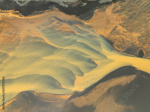Aerial view of beautiful glacial river with vibrant patterns and serene landscape, Hvolsvollur, Southern Region, Iceland.