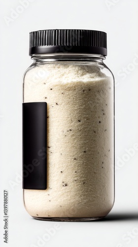 A transparent jar filled with a light-colored powder, featuring a black lid and a blank label on its side.