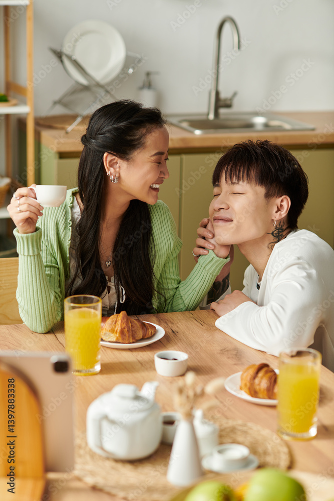 Joyful breakfast moments shared by a young asian couple in their cozy home Joyful breakfast moments shared by a young asian couple in their cozy home