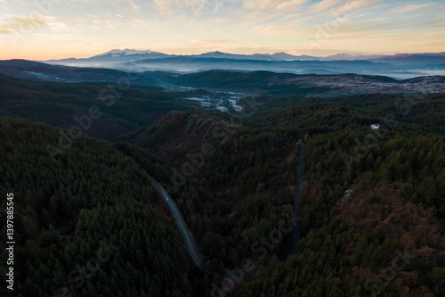 Aerial view of serene sunset over lush Rhodope Mountains with tranquil forest and picturesque valley, Krushevo, Blagoevgrad, Bulgaria. photo