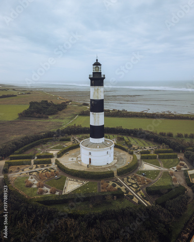 Aerial view of the beautiful Phare de Chassiron lighthouse with a scenic garden and coastline, Saint-Denis-d'Oleron, Charente-Maritime, France. photo