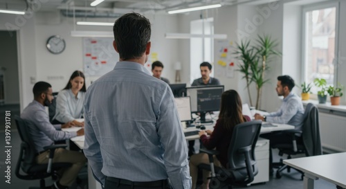 Multiracial Office Team Collaborating Under Supervision of Caucasian Male Manager in Modern Workspace