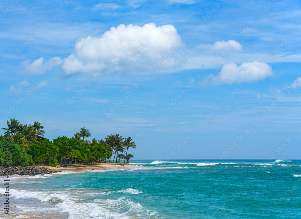 Koggala beach with blue cloudy sky and foamy waves, Koggala, Sri Lanka, Asia Koggala beach with blue cloudy sky and foamy waves, Koggala, Sri Lanka, Asia