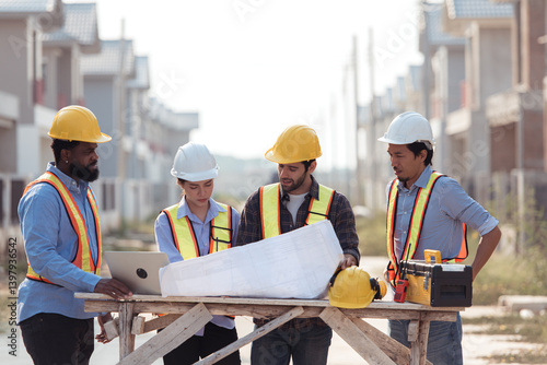 Group of architects and engineers work together to assess the residential home construction site's progress