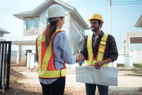 Architects and engineers work together to assess the residential home construction site's progress
