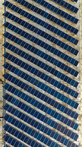 Obraz na płótnie Aerial perpendicular view of rows of solar panels installed on the roof of a building. Clean energy concept. w salonie