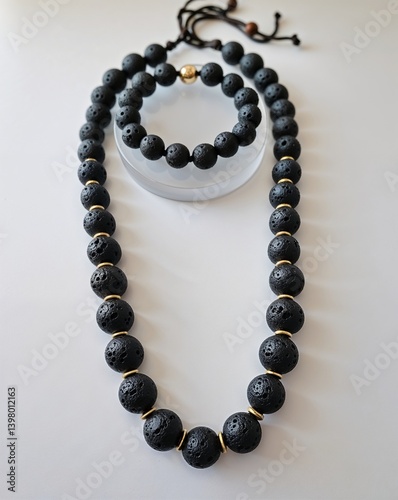 A lava rock bead necklace and bracelet jewelry set in plain white background
