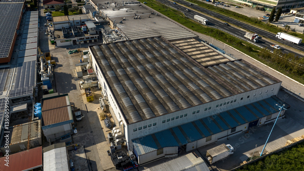 Aerial view of a factory with a large warehouse.