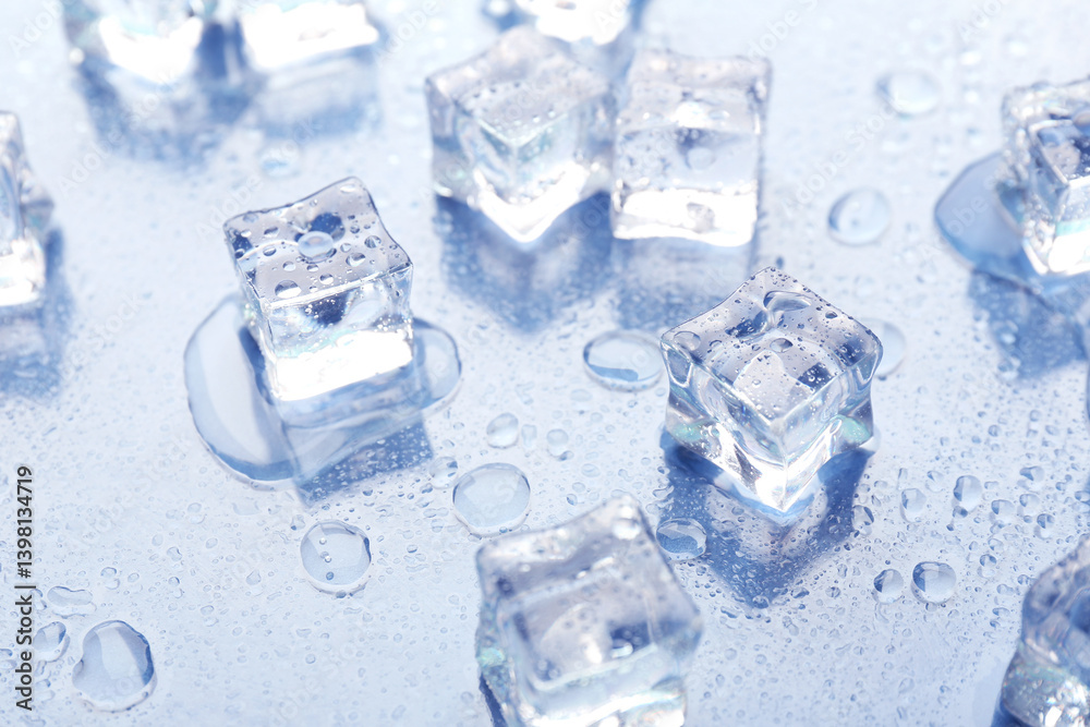 Melting ice cubes and water drops on light background, closeup Melting ice cubes and water drops on light background, closeup